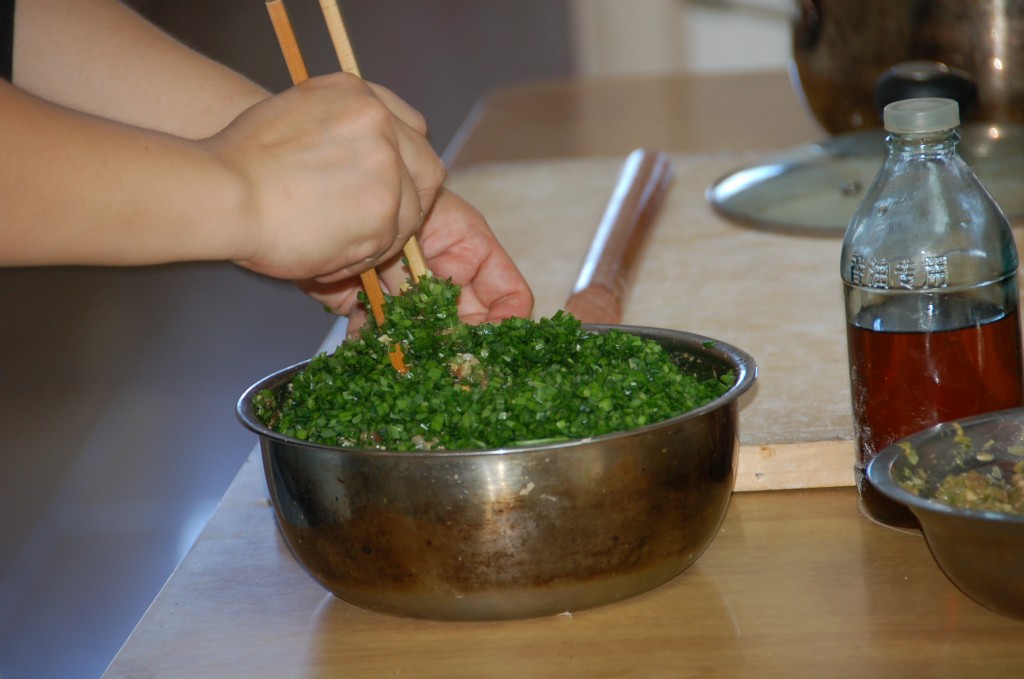 Stirring the green onions into the egg, pork and shrimp mixture