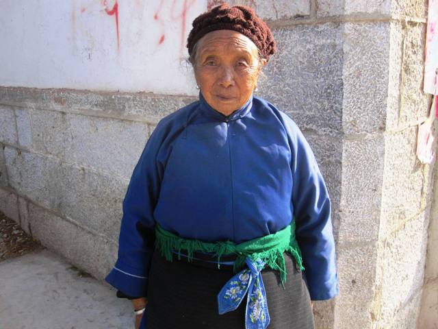 Old Woman in Traditional Dress at Village Market.  Erhai Lake