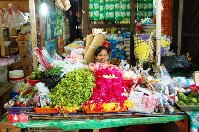 Lady selling flower petals just inside the main entrance. These are used to decorate graves.