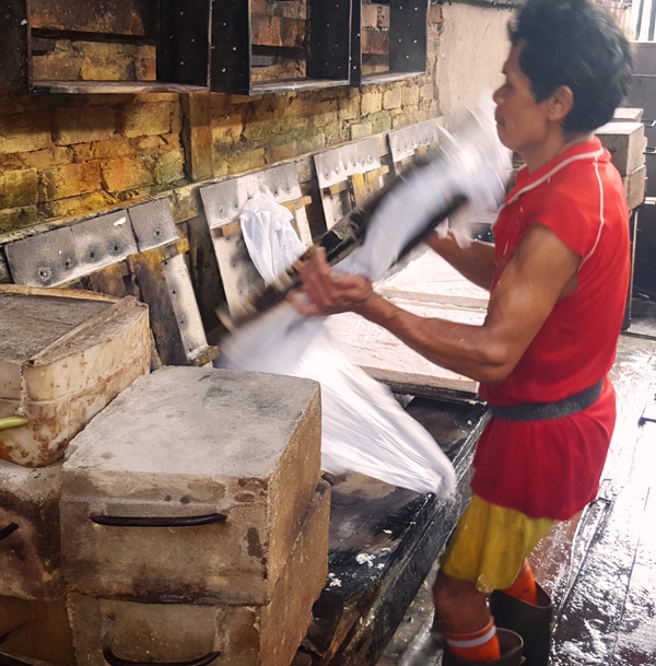 Flipping pressed tofu molds.Indonesia tofu factory