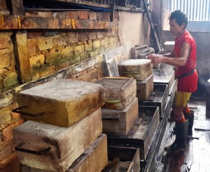 Pressing tofu molds.Balikpapan, Kalimantan, Indonesia tofu factory
