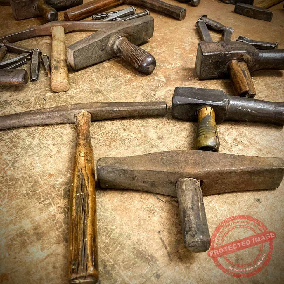 Collection of centuries-old hammers at the Bottega Storica Dal Toso in Vicenza, Italy