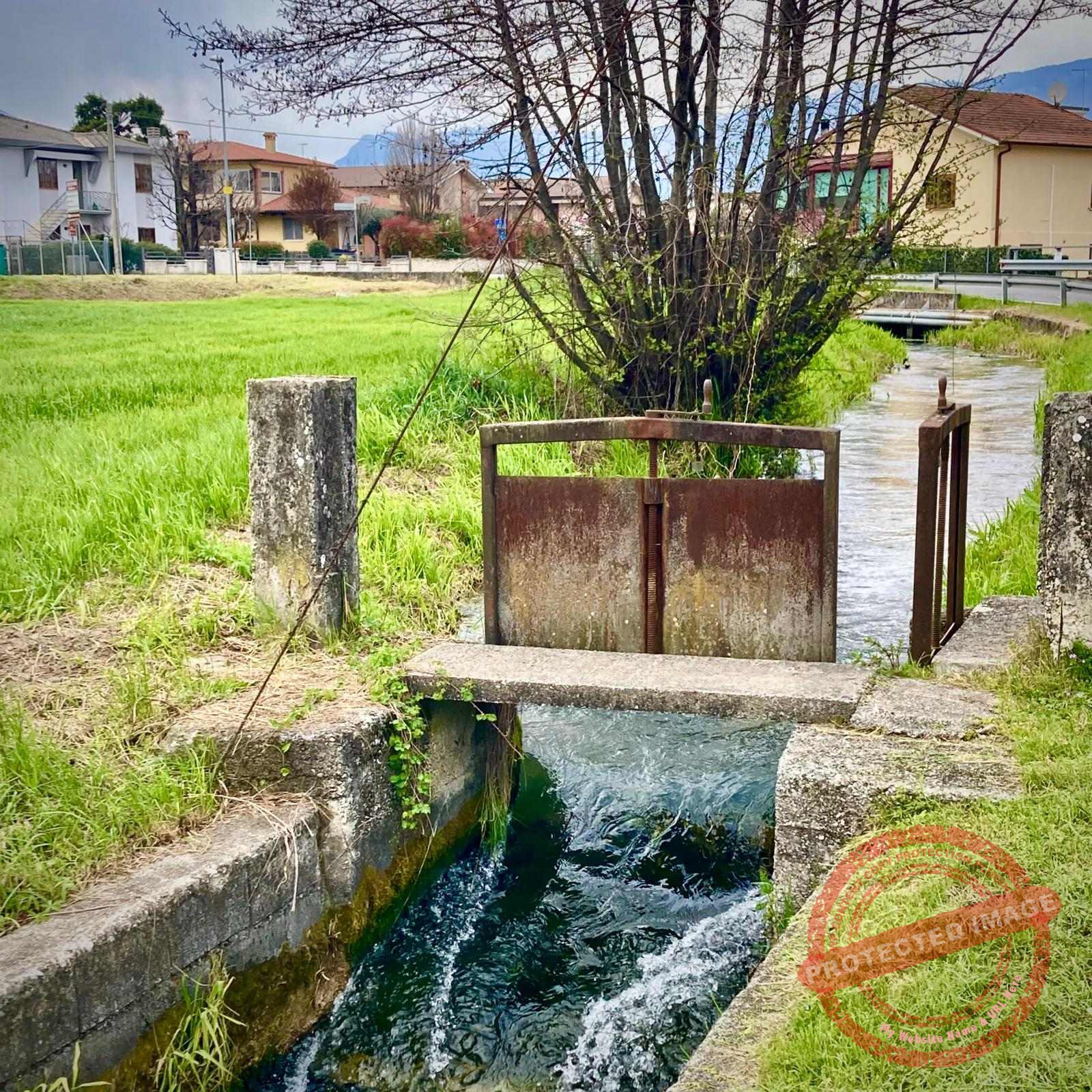 Clever dam spillway for family farmland near Thiene, Italy
