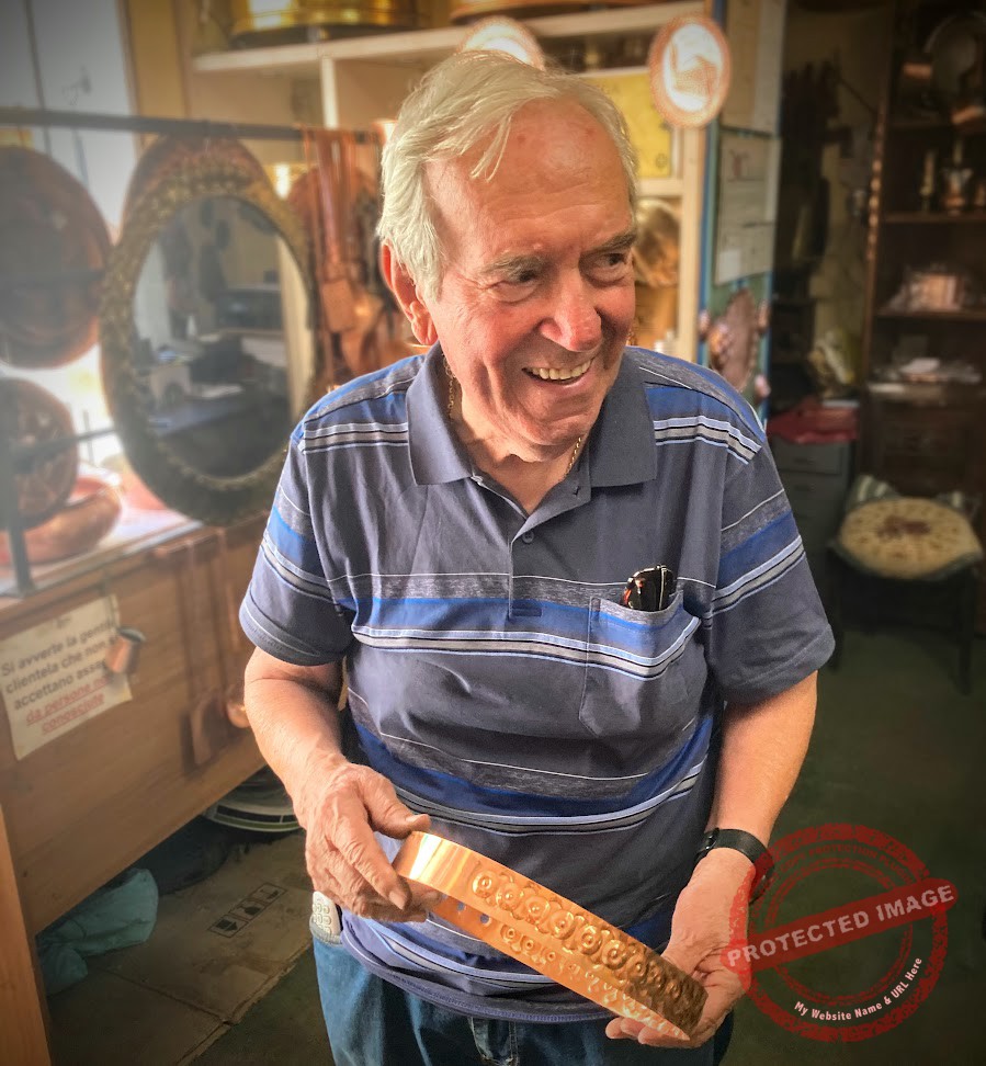 Luigi Dal Toso holding one of his copper belts at the Bottega Storica Dal Toso in Vicenza, Italy