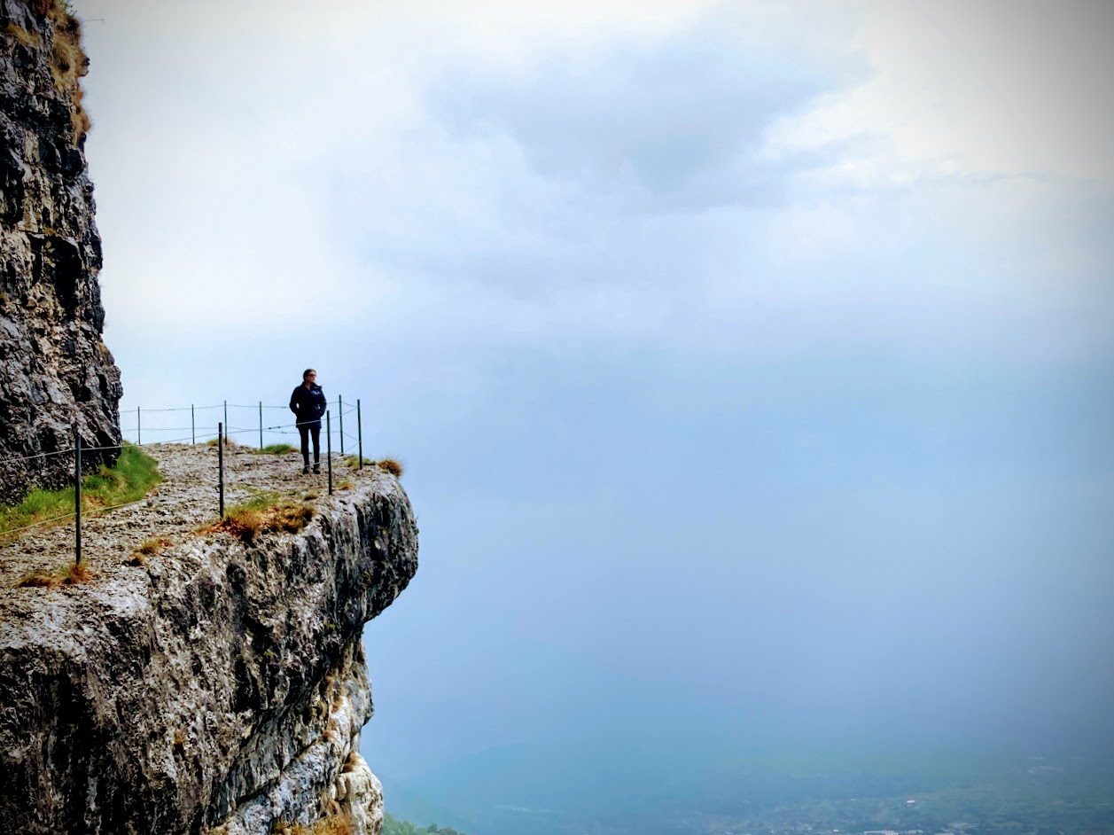Walking along the ledge path of La Granatieri at Monte Cengio, Italy